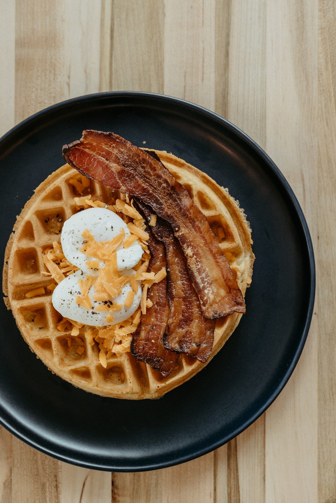 Canadian brunch waffle on a black plate